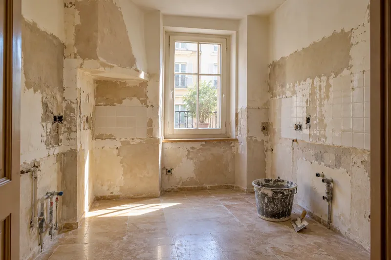 Visualización conceptual IA: Cocina sin muebles con paredes en preparación y zonas de enlucido.